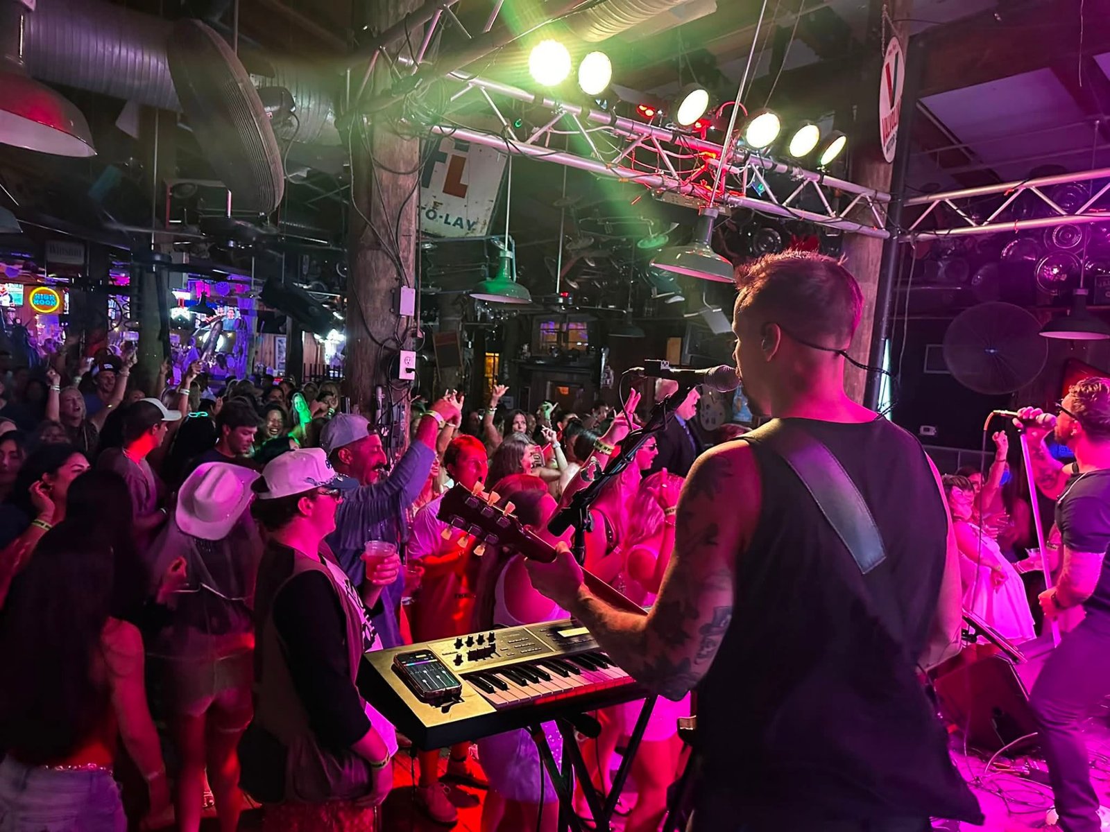 Keys and vocals in front of a packed dance floor