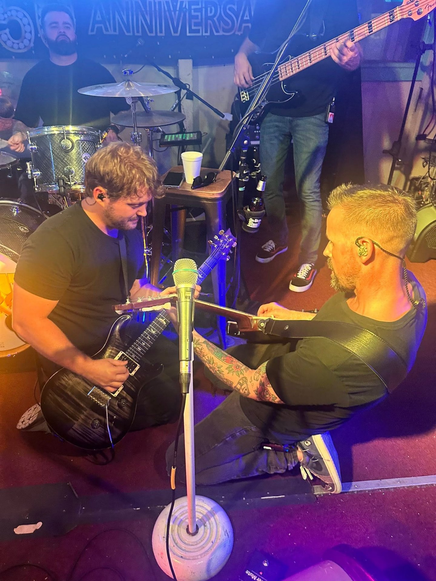 Richard Murphy and Michael Padilla trading guitar parts on stage